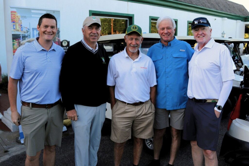 men smiling at golf tournament