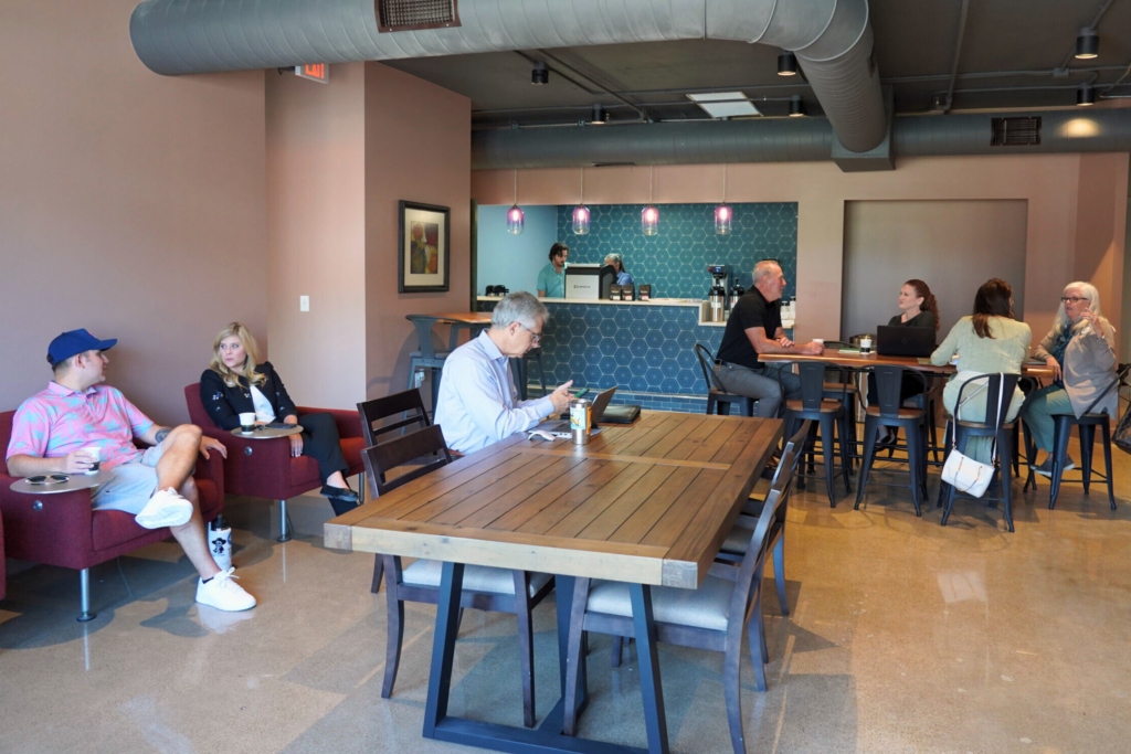 people sitting, working, and conversing at co-work and coffee