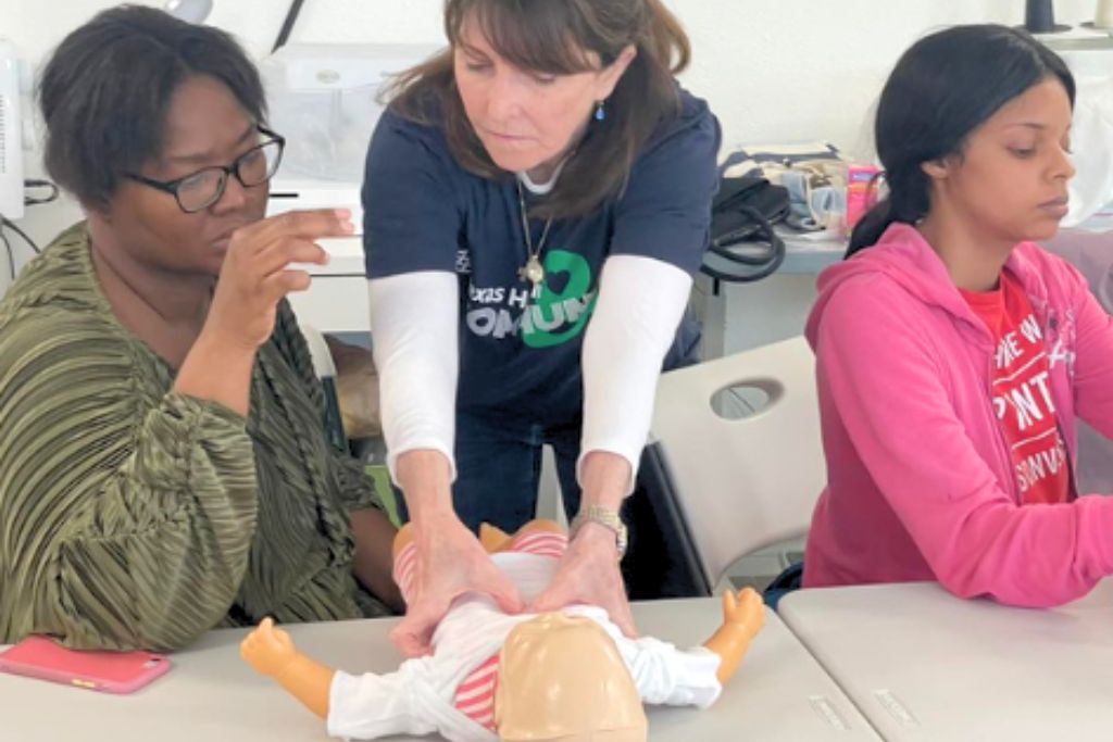nurse training mothers on safety for their child