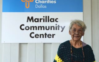 Molly, a senior in Dallas, standing outside the Brady Senior Center after receiving food assistance and case management support.