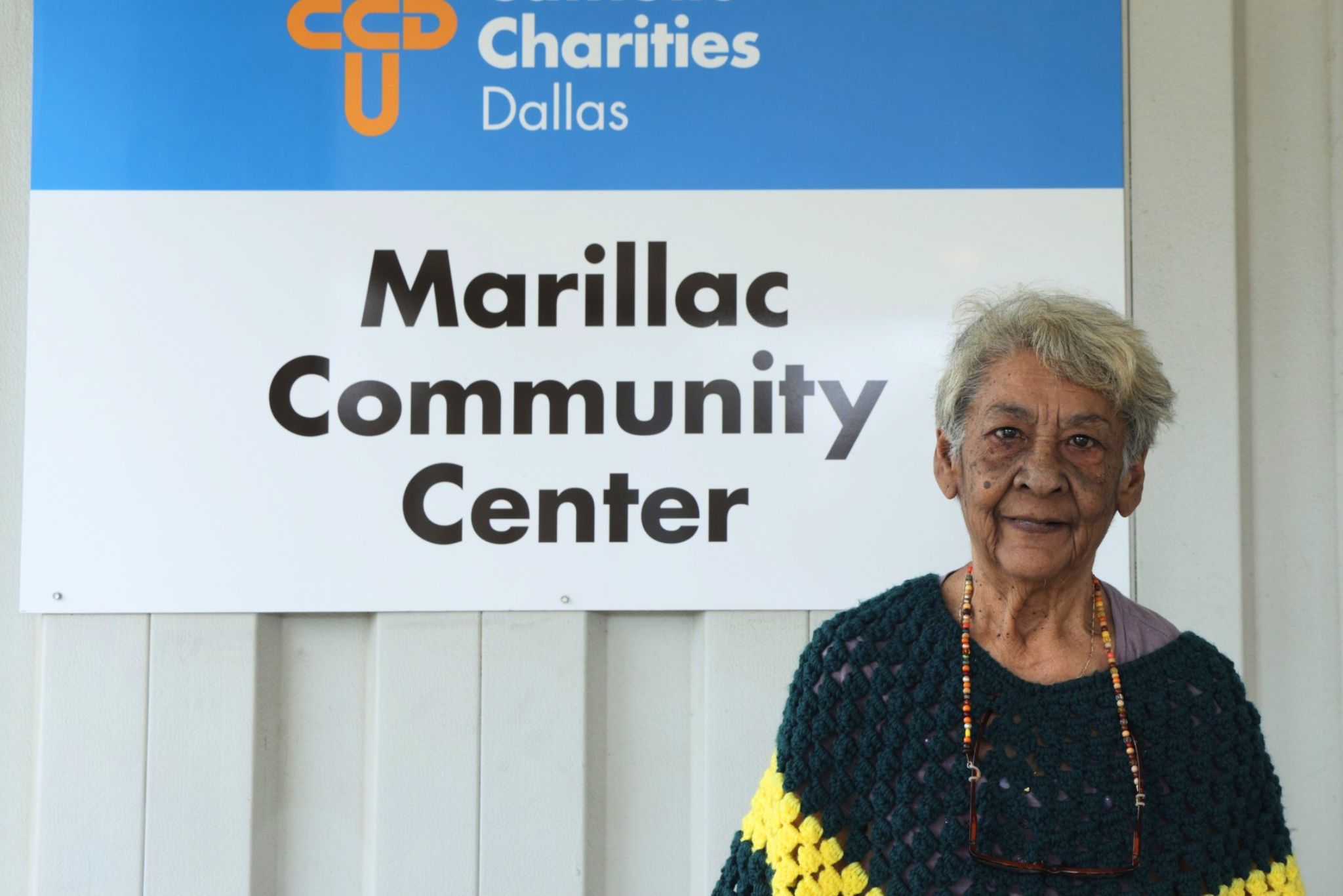 Molly, a senior in Dallas, standing outside the Brady Senior Center after receiving food assistance and case management support.