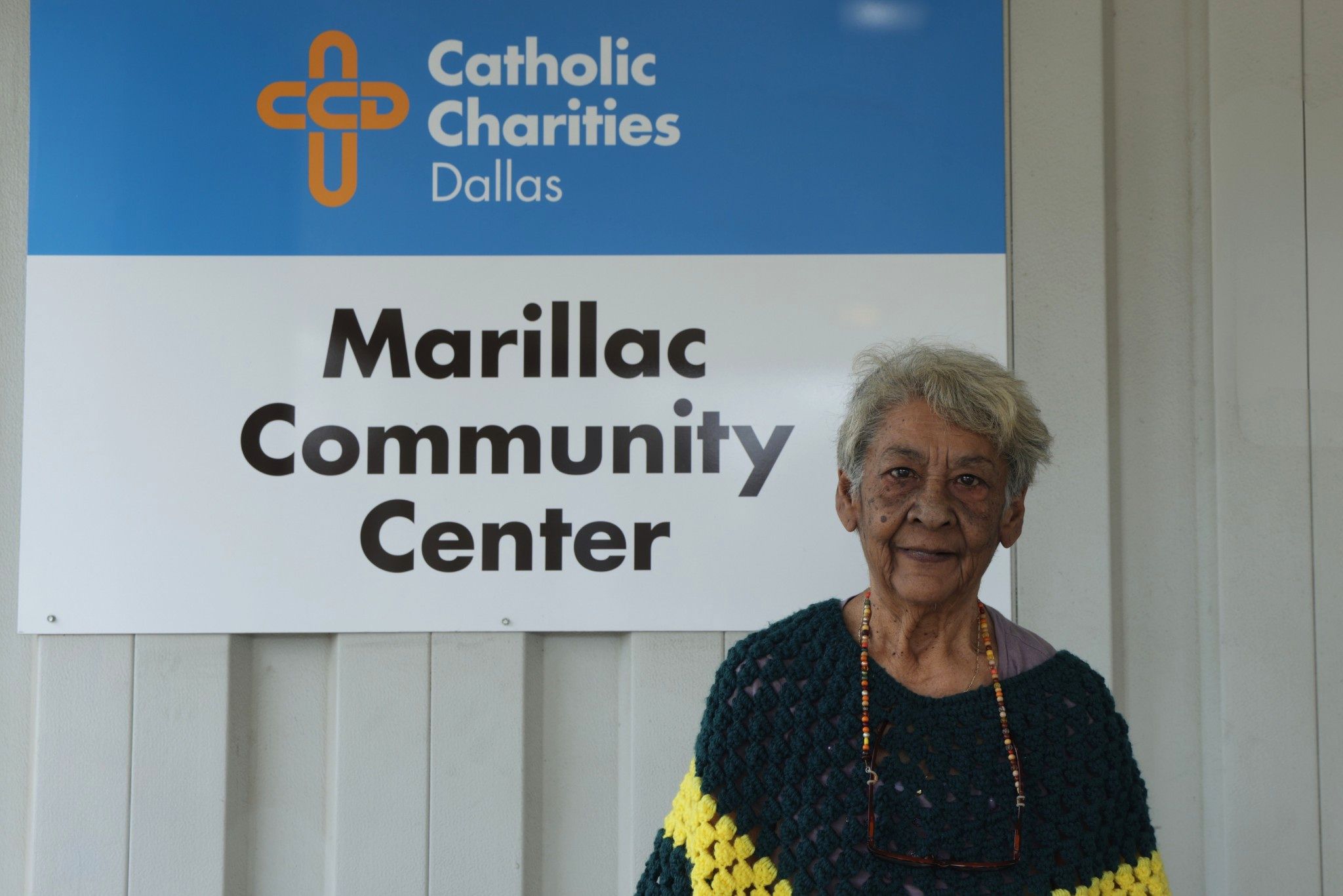 Molly, a senior in Dallas, standing outside the Brady Senior Center after receiving food assistance and case management support.