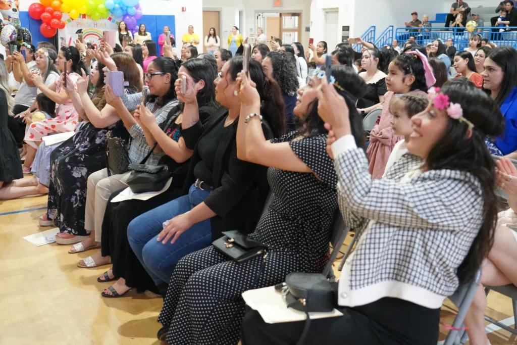 parents taking photos and cheering at twl graduation