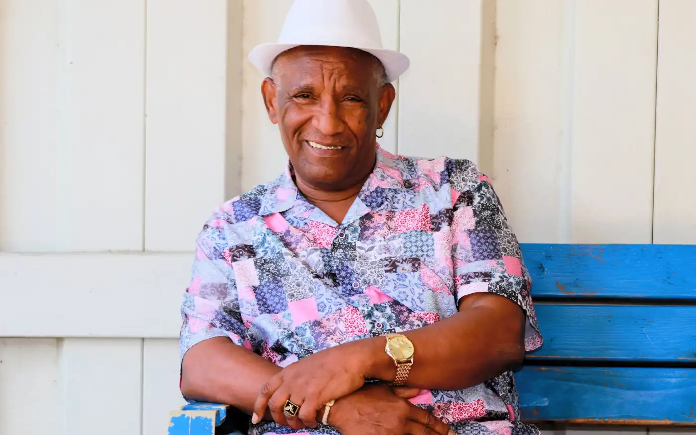 Andres smiling while sitting on a bench