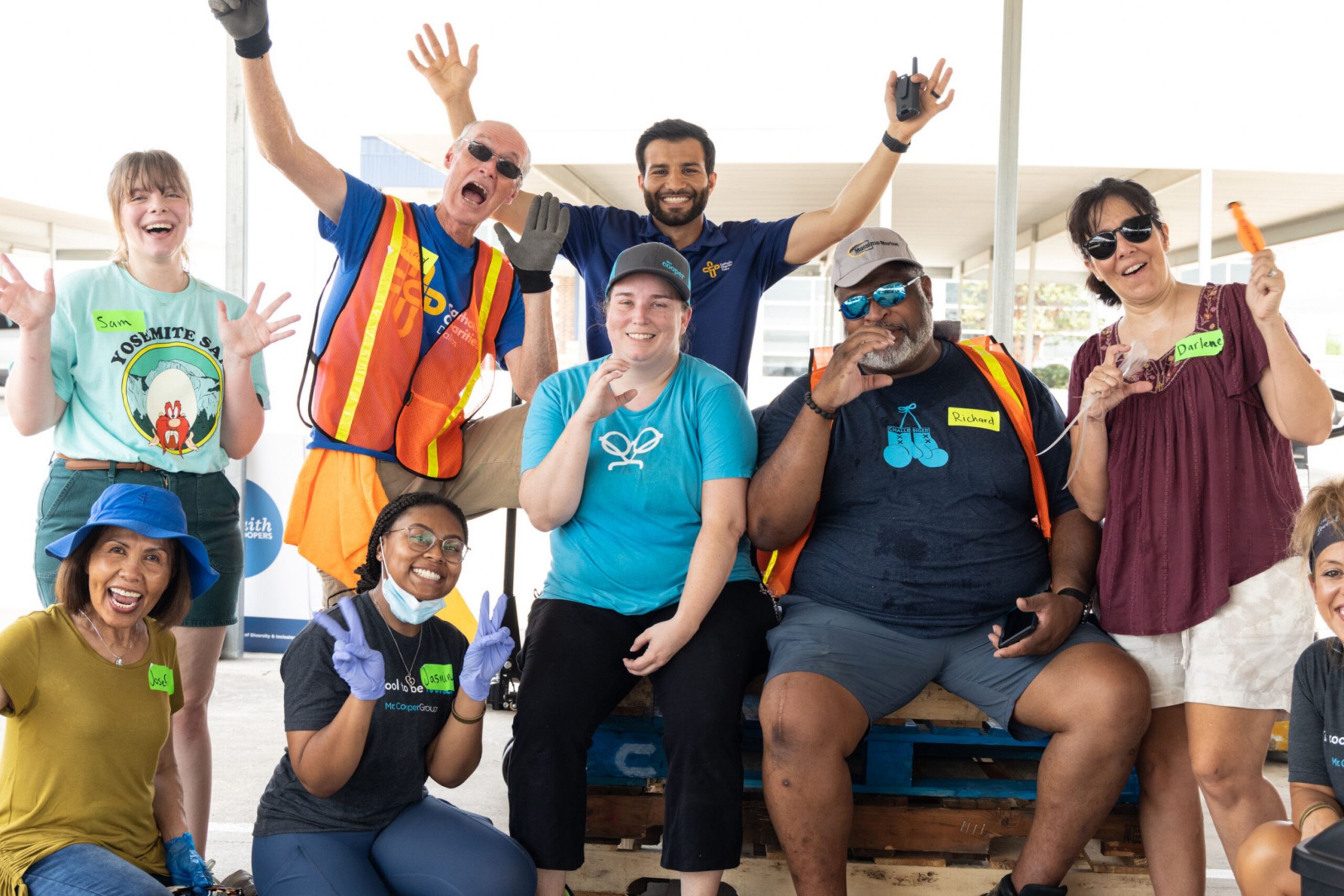 Catholic Charities Dallas volunteers smiling and waving